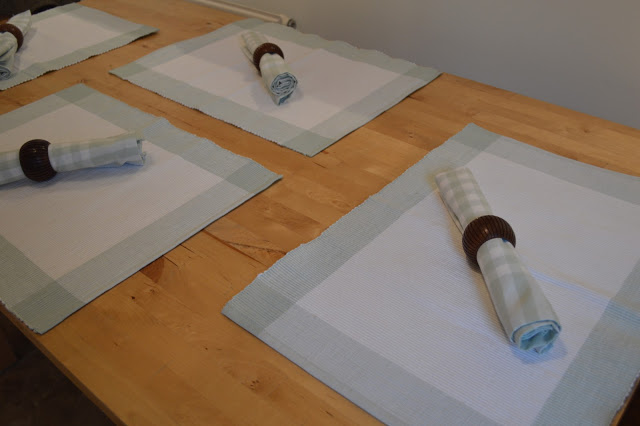 Table set for four with John Lewis napkins and table mats