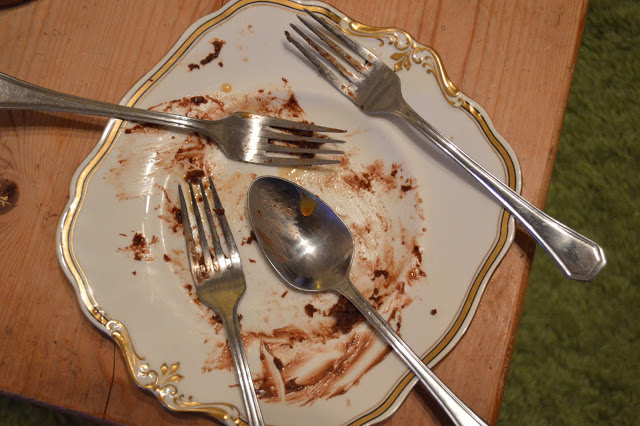 Empty chocolate cake plate with forks 