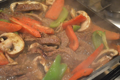 Steak, peppers and mushrooms in the griddle pan