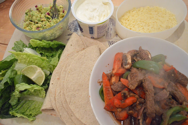 Steak fajitas with guacamole, salad and soured cream