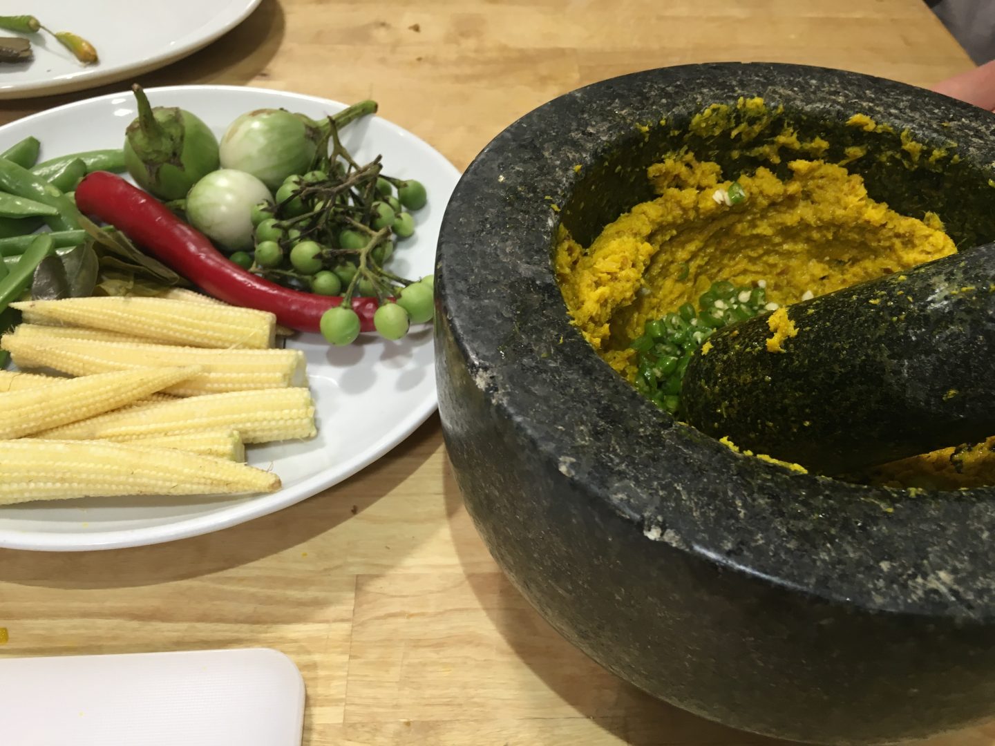 Using a pestle and mortar to make curry paste