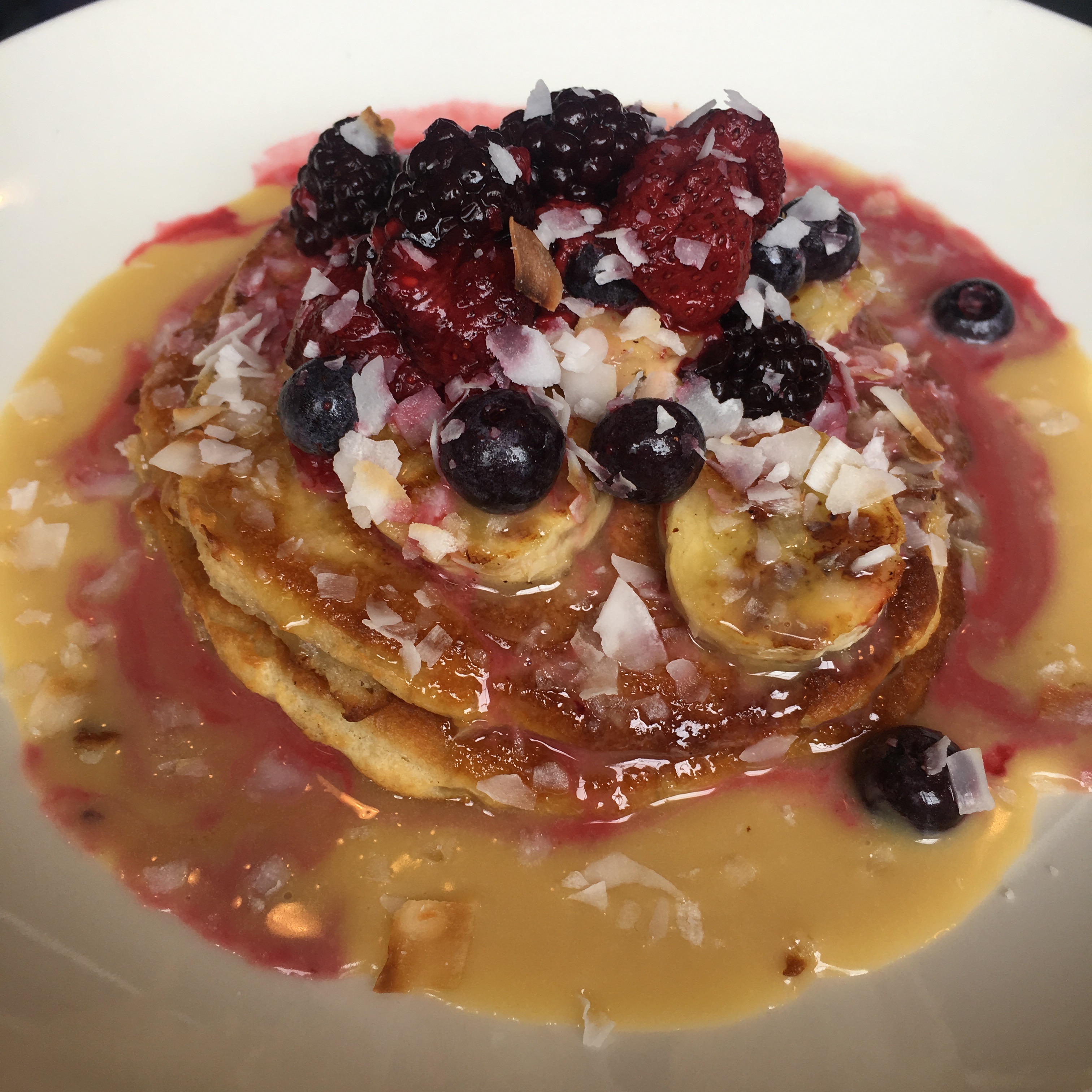 Coconut pancakes with fruit coulis and berries